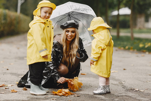 Funny kids in rain boots playing in a rain park - Zdjęcie, obraz