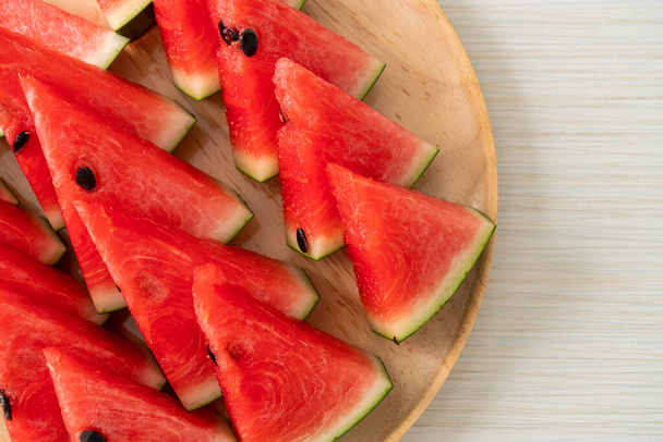 fresh watermelon sliced on wooden plate - 写真・画像