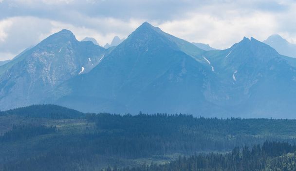 A scenic view of the Tatra mountains on a blue sky background - Zdjęcie, obraz