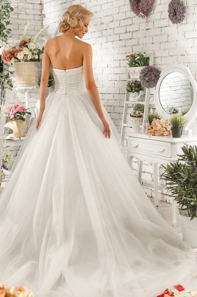 The beautiful  woman posing in a wedding dress - Zdjęcie, obraz