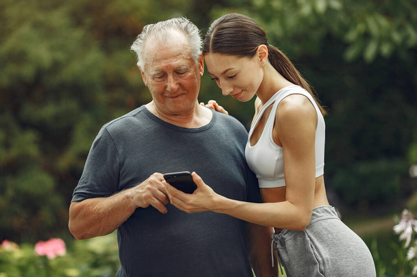 Portrait of happy handsome older man using smartphone - Foto, afbeelding