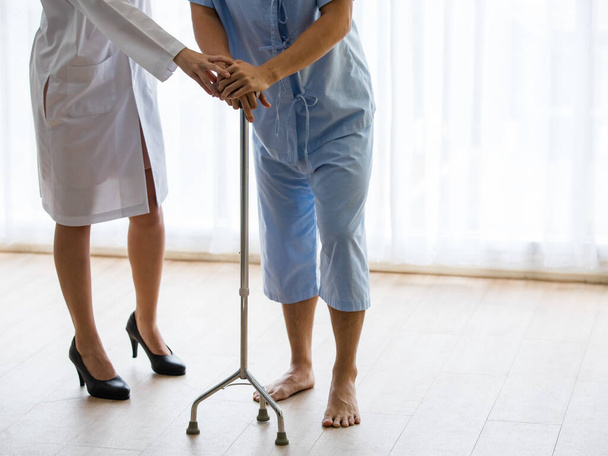 Patient use walker for help to walk by get assist from caregiver. For physiotherapist patient might need physiotherapy equipment to help for a while or in some case may need to use all rest of life - Photo, Image
