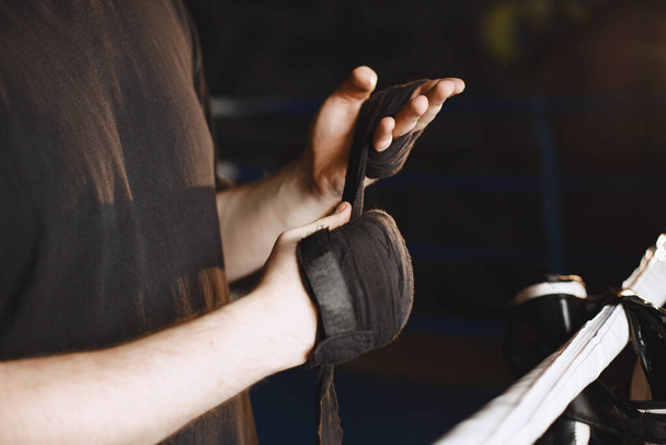 Man in a black t-shirtg boxing in a gym - Photo, Image