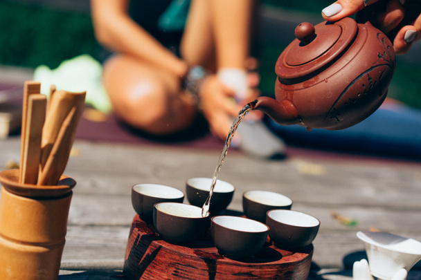 Teezeremonie, Frau gießt traditionell zubereiteten Tee - Foto, Bild
