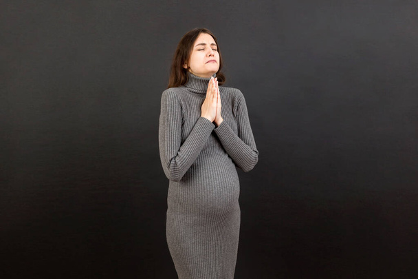 cute pregnant woman praying on colored background isolated. - Fotoğraf, Görsel