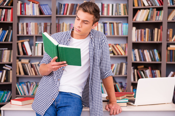 Confident young man reading book - Photo, Image