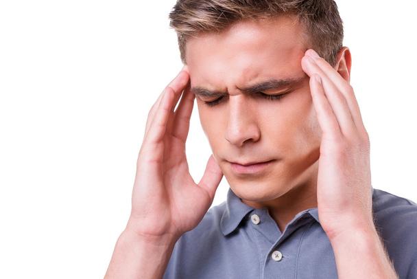 Депрессивный молодой человек чувствует головную боль
 - Фото, изображение