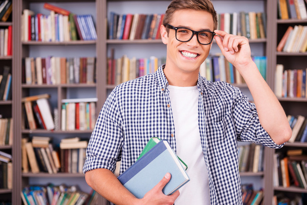 Handsome young man holding books - Photo, image