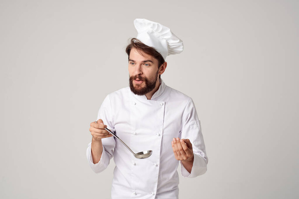 professional male chef with a ladle in his hands working in a restaurant - Photo, Image