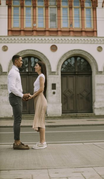 Handsome young multiethnic couple standing on the street - Foto, imagen