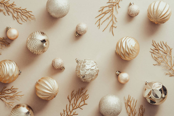 Christmas flat lay composition with golden balls and Xmas tree branches on beige background. Flat lay, top view. - Foto, Imagem