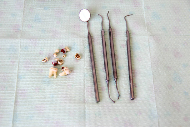 Dental instruments and extracted teeth on the napkin - Photo, Image
