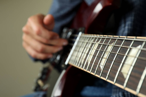 Musician playing on electric guitar, close up and selective focus - Photo, Image