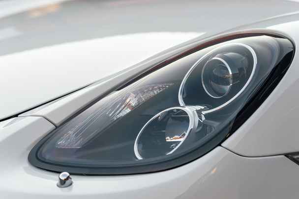 Close up part of automobile. The headlight of a modern luxury sport car from a close angle. - Foto, imagen