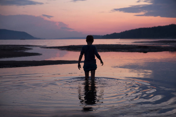 silhouette of a boy on the beach  - Zdjęcie, obraz