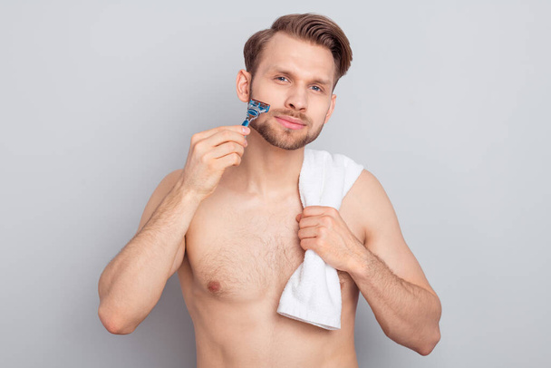 Photo of pretty good mood young blond hair gentleman wear nothing shaving cheeks cheekbones isolated grey color background - Foto, Bild