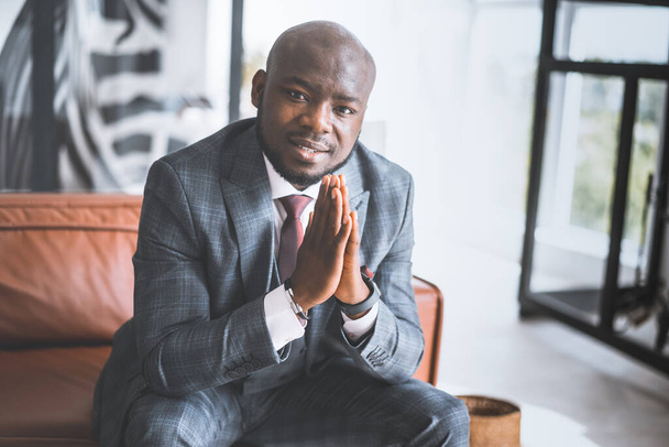 Successful Young Businessman. African American Guy In Stylish Expensive Suit Folded His Palms Together Looking Directly Into Camera. Concept Of Victory, Personal Growth - Fotó, kép
