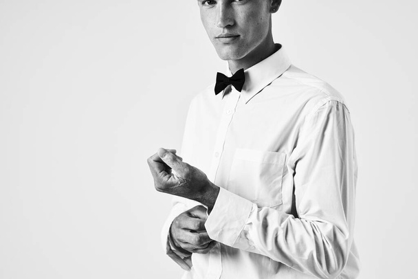 man in white shirt bow tie portrait light background - Photo, Image