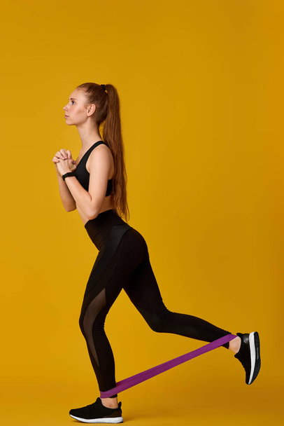 woman in sportswear exercising with rubber resistance band - Φωτογραφία, εικόνα