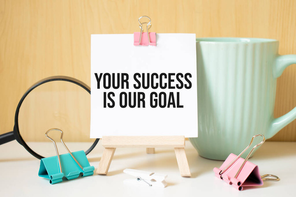 Your success is our goal text written on black notebook with magnifying glass and a pen. Business and achievement concept. - Foto, immagini