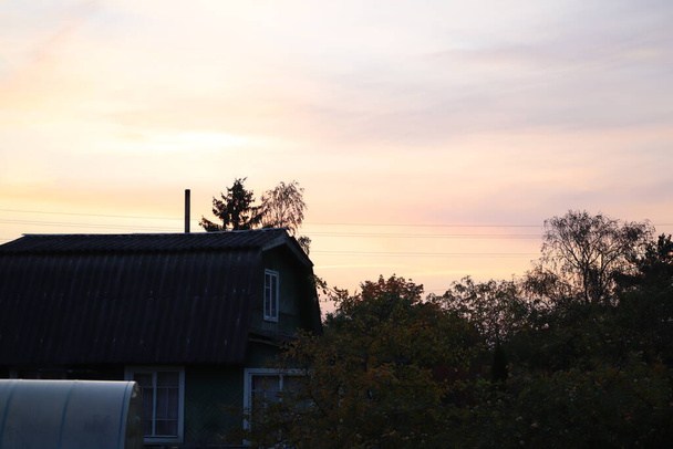 view you can only get on the countryside - beautiful sunset view from the village house roof - Photo, Image