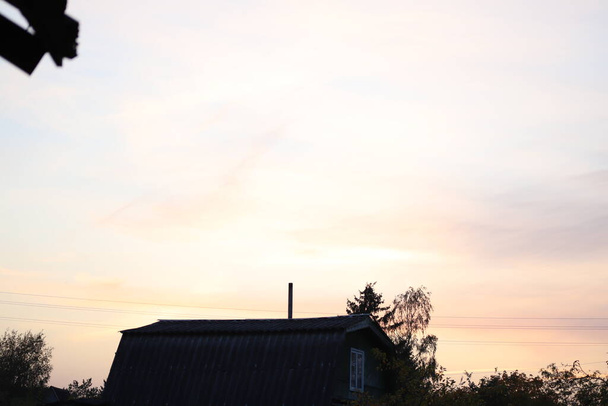 view you can only get on the countryside - beautiful sunset view from the village house roof - Photo, Image
