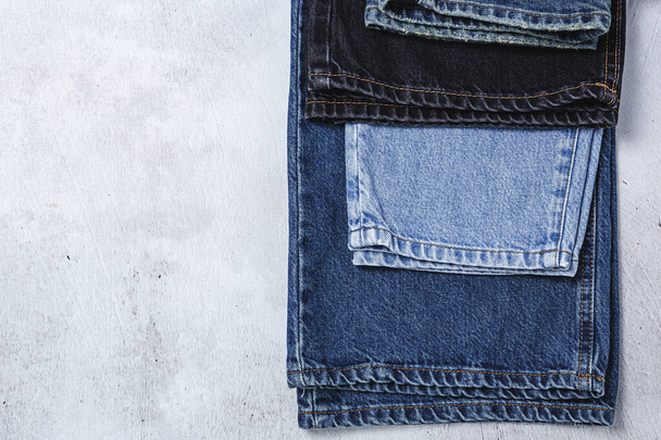Handicraft, clothing repair. Ripped blue jeans sewing accessories from above. Flat lay - Valokuva, kuva