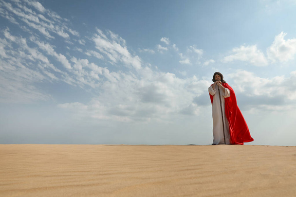 Jesus Christ walking with stick in desert. Space for text - Foto, immagini
