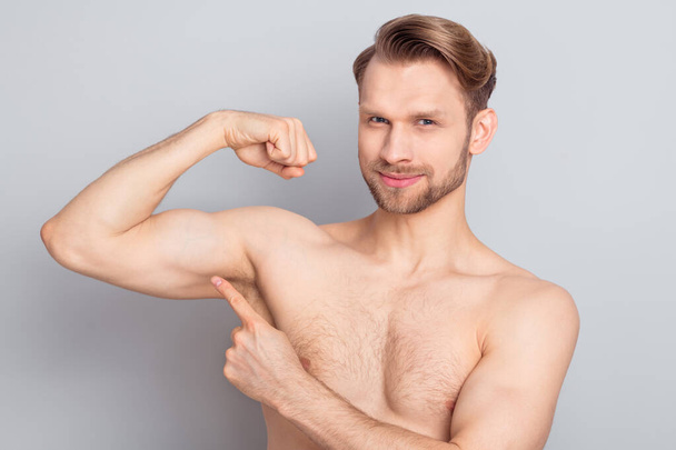 Photo of sweet cute young blond hair gentleman wear nothing pointing finger arm biceps smiling isolated grey color background - Foto, Imagem
