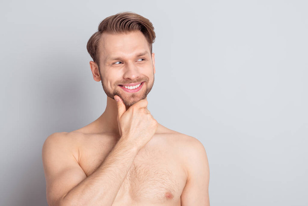 Photo of curious muscle blond hairdo guy hand face look empty space without clothes isolated on grey color background - Valokuva, kuva