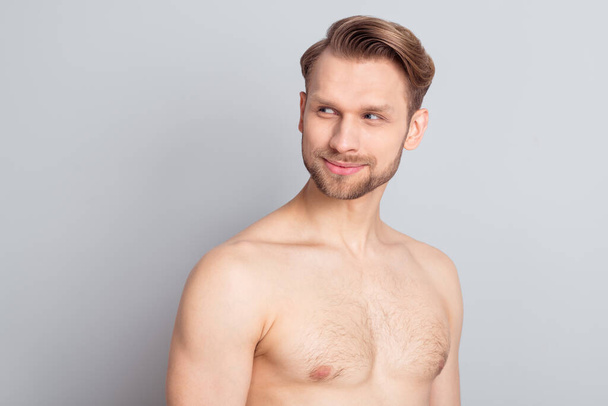 Photo of millennial blond hairdo guy look empty space without clothes isolated on grey color background - Фото, изображение