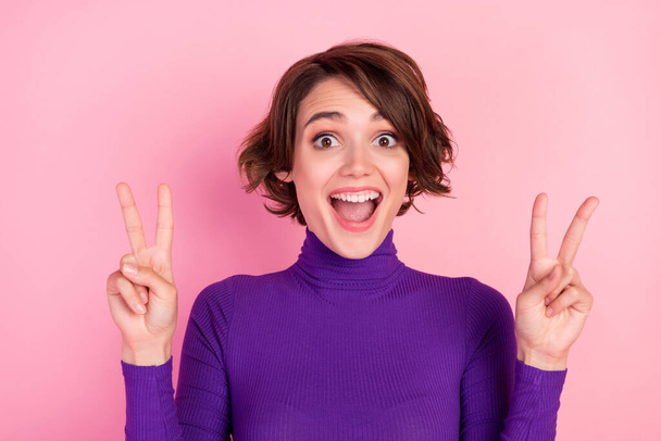 Photo of funky brunette millennial lady show v-sign wear violet pullover isolated on pink color background - Valokuva, kuva
