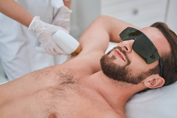 Patient during a non-invasive medical procedure performed by a cosmetician - Photo, Image