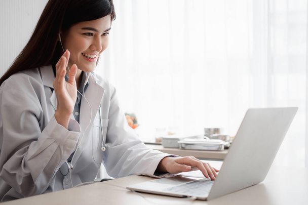 Aziatische therapeut vrouw arts is online op bezoek met een patiënt op het internet applicatie. Haar Luisteren en geven van advies en legt uit hoe de eerste ziekte te behandelen, Concept van medische technologie. - Foto, afbeelding