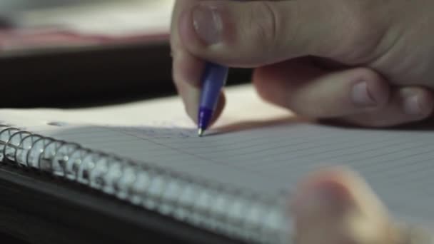 A person writes notes on a sheet of paper with a Pen. - Felvétel, videó