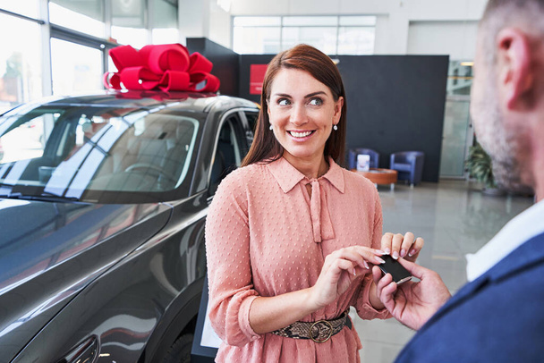 Unrecognized man presenting new car to his wife - Photo, Image