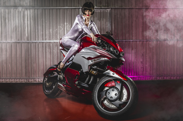 Woman in latex mounted on a motorcycle - 写真・画像