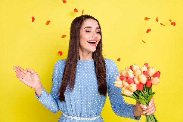 Photo of charming pretty young lady wear dotted outfit smiling enjoying bunch aroma isolated yellow color background - Φωτογραφία, εικόνα