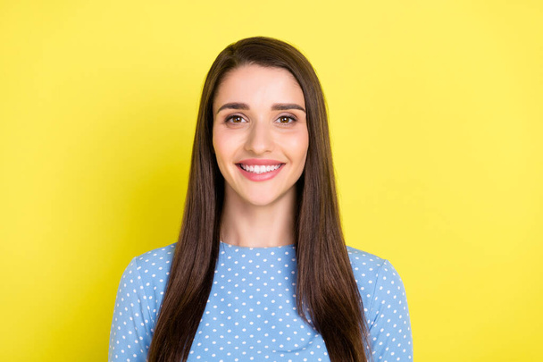 Photo of charming cheerful positive girl toothy beaming smile wear dotted blue dress isolated yellow color background - Foto, immagini