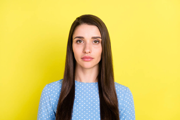 Photo of serious charming young lady wear dotted outfit isolated yellow color background - Фото, изображение