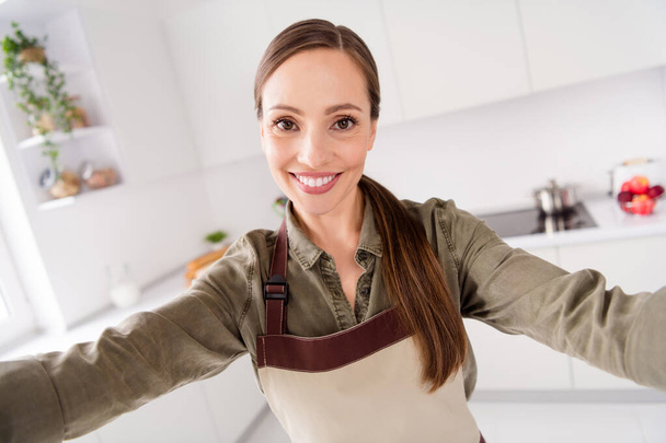 Photo of sweet shiny housemaid wear brown apron smiling cooking recording video indoors room home house - Valokuva, kuva