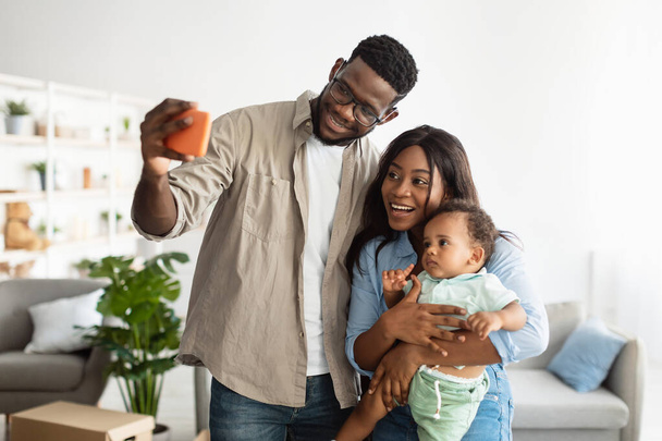 Happy African American family taking selfie together at home - Photo, Image