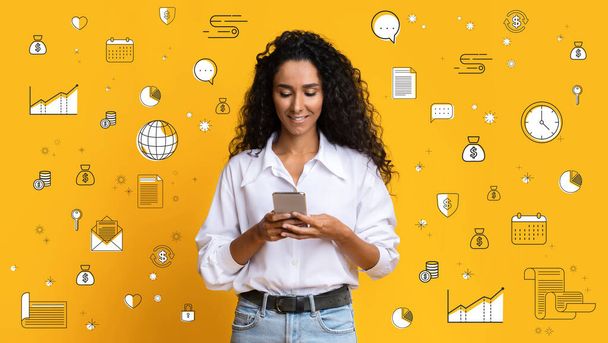 Happy Hispanic young woman with smartphone checking online banking app, collage with business and money related icons - Photo, Image