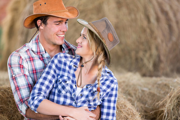 loving american western couple in barn - Foto, Imagen