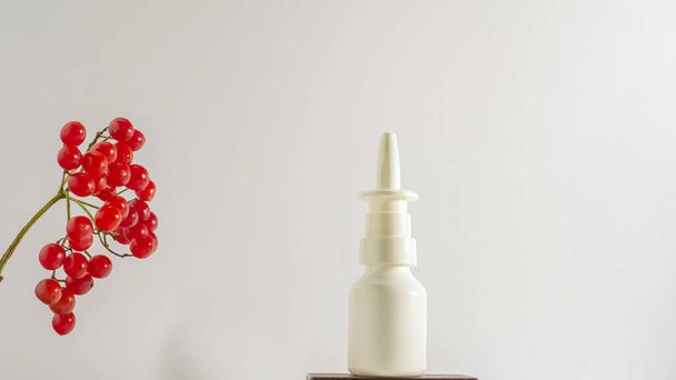 Rowan berry medicine on white background copy space. Rowan branch with medicinal jar. Homeopathy - Valokuva, kuva