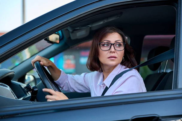 Middle-aged beautiful woman driver driving a car - Fotó, kép
