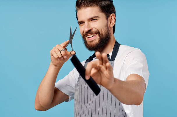 male hairdresser scissors comb blue background - Valokuva, kuva