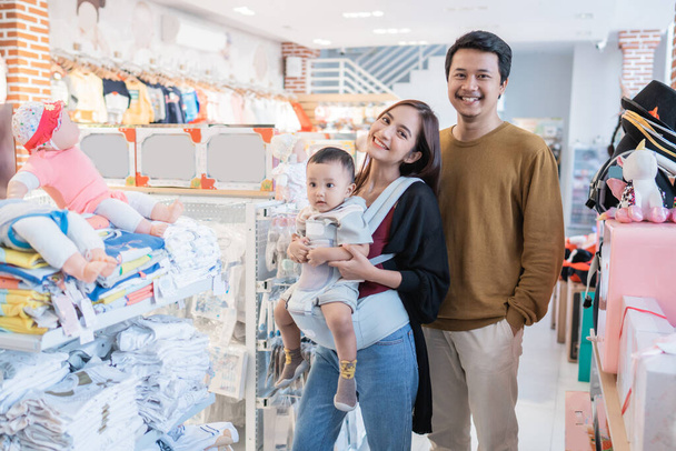 asian family with kid buying baby product at the mall - Фото, изображение