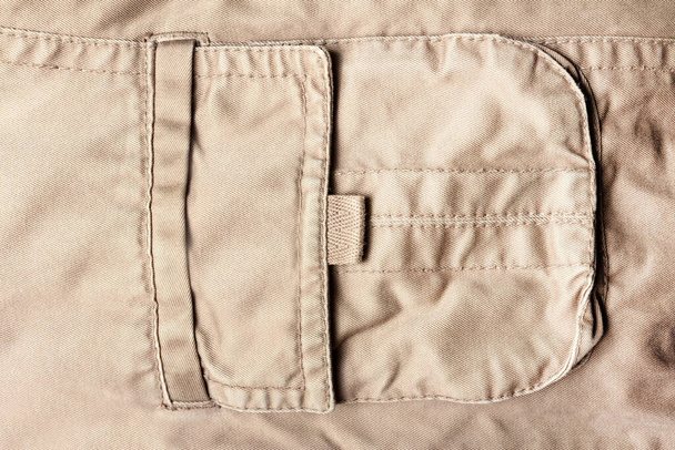 Tekstura tło zdjęcie z beżowym kolorze jeansowej kieszeni tkaniny. - Zdjęcie, obraz