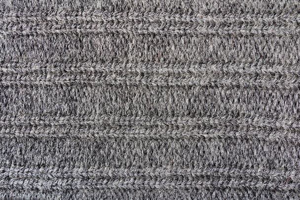 Textur Hintergrund Foto von grau gefärbten Wolle Strickstoff. - Foto, Bild